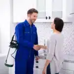 Pest Control Worker Shaking Hands With Woman